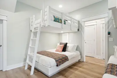 a white bunk bed in a white room with a ladder at Grand Retreat II: 4BR, 5BA, sleeps 15 Private pool Your perfect escape! in Panama City Beach