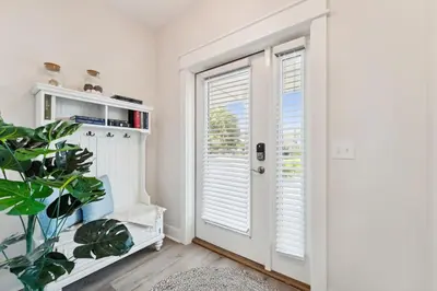a white room with a door and a plant at Grand Retreat II: 4BR, 5BA, sleeps 15 Private pool Your perfect escape! in Panama City Beach