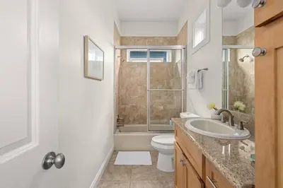a bathroom with a sink and a toilet and a tub at Modern Beach Haüs 4 min walk to beach w/ pool BBQ in Panama City Beach
