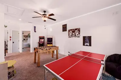 a living room with a ping pong table in it at Sand Castle in Panama City Beach