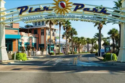 a sign over a street in front of a resort at Sand Castle in Panama City Beach