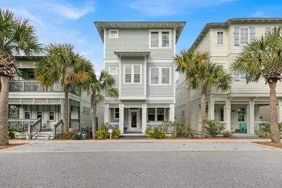 a house with palm trees in front of it at The Java House in Rosemary Beach