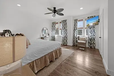 a bedroom with a bed and a ceiling fan at The Java House in Rosemary Beach