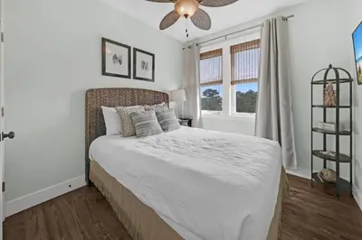 a bedroom with a bed and a ceiling fan at The Java House in Rosemary Beach