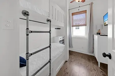 a bedroom with a bunk bed and a window at The Java House in Rosemary Beach