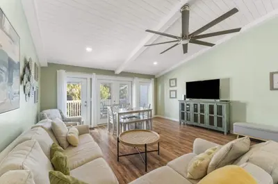 a living room with a couch and a ceiling fan at Solitude on 30A - Seacrest Beach - Beach Access in Rosemary Beach