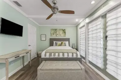 a bedroom with a bed and a ceiling fan at Solitude on 30A - Seacrest Beach - Beach Access in Rosemary Beach