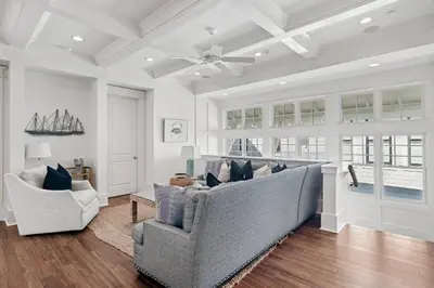 a living room with a couch and two chairs at Barefoot at the Beach in Watersound Beach