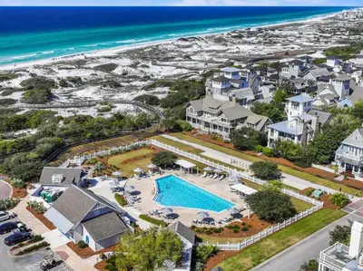 an aerial view of a resort with a pool and the beach at Barefoot at the Beach in Watersound Beach