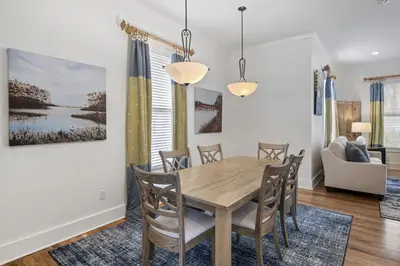 a dining room with a wooden table and chairs at My Blue Heaven in Rosemary Beach