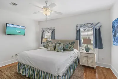 a bedroom with a bed and a ceiling fan at My Blue Heaven in Rosemary Beach