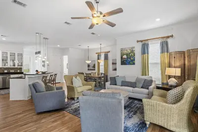 a living room with couches and chairs and a kitchen at My Blue Heaven in Rosemary Beach