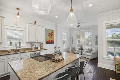 a kitchen with white cabinets and a counter top at Sunny Day in Seagrove Beach