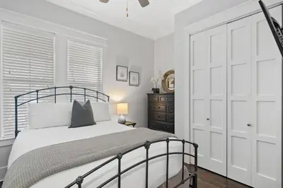 a white bedroom with a bed and a closet at Sunny Day in Seagrove Beach