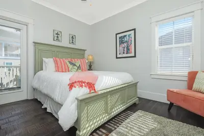 a bedroom with a bed and a chair at Sunny Day in Seagrove Beach