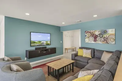 a living room with a couch and a flat screen tv at Ashore Thing in Inlet Beach