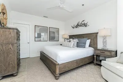 a bedroom with a large bed and a couch at B402 Sunset Beach Villa in Inlet Beach