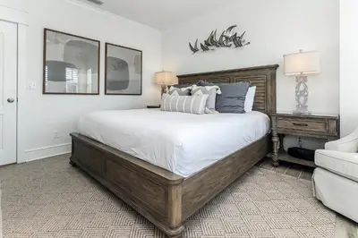 a bedroom with a large bed and a couch at B402 Sunset Beach Villa in Inlet Beach