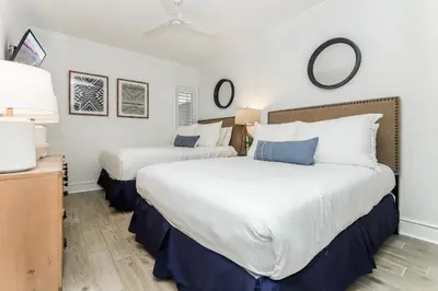 two beds in a room with white and blue at B402 Sunset Beach Villa in Inlet Beach