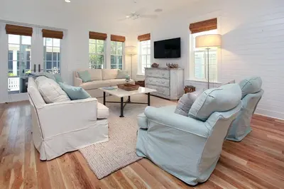 a living room with two chairs and a tv at Southern Charm in Santa Rosa Beach