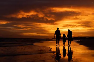 a family walking on the beach at sunset at Southern Charm in Santa Rosa Beach