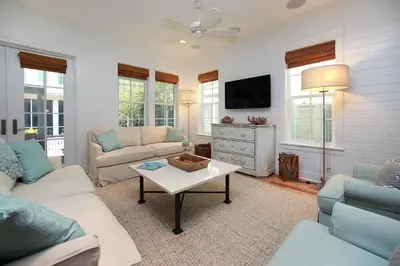 a living room with a couch and a tv at Southern Charm in Santa Rosa Beach