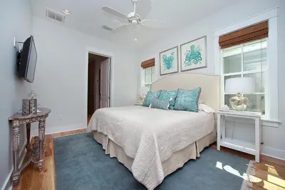 a bedroom with a bed and a ceiling fan at Southern Charm in Santa Rosa Beach