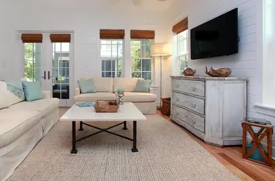 a living room with a couch and a tv at Southern Charm in Santa Rosa Beach