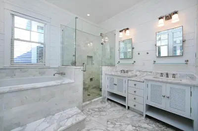 a white bathroom with two sinks and a tub and a shower at Pura Vida in Watersound Beach