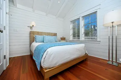 a bedroom with a bed in a room with white walls at Pura Vida in Watersound Beach