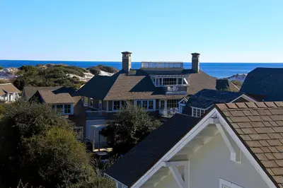 a group of houses with the ocean in the background at Pura Vida in Watersound Beach