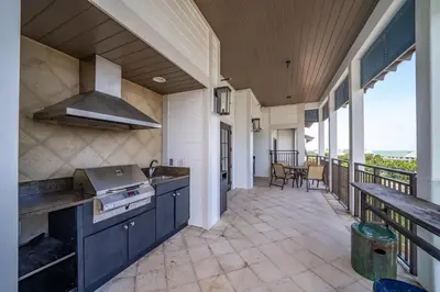 a kitchen with a stove and a balcony at WaterHouse 401 in Seacrest
