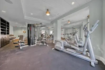 a gym with treadmills and ellipticals in a room at WaterHouse 401 in Seacrest