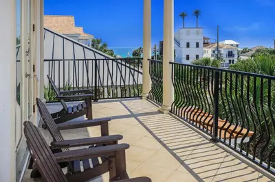 two chairs sitting on a balcony with a view of the ocean at Buena Vista in Santa Rosa Beach