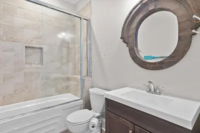 a bathroom with a toilet and a sink and a mirror at Buena Vista in Santa Rosa Beach