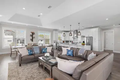 a living room with a couch and a kitchen at Buena Vista in Santa Rosa Beach