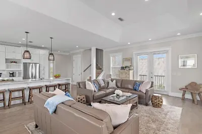 a living room with two couches and a kitchen at Buena Vista in Santa Rosa Beach