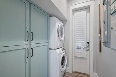 a laundry room with a washer and dryer in it at Sip N' Sea in Seacrest
