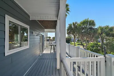 a porch of a house with a table and chairs at Caribbean Breeze in Seacrest