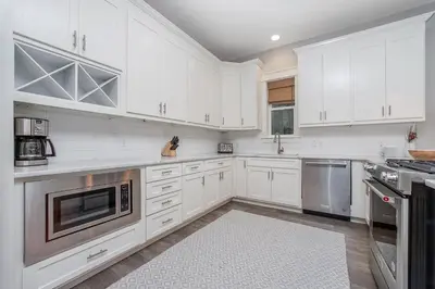 a kitchen with white cabinets and stainless steel appliances at 110 Surfer Lane in Inlet Beach