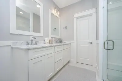 a white bathroom with a sink and a shower at 110 Surfer Lane in Inlet Beach