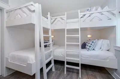 a white bunk bed with two beds in a room at 110 Surfer Lane in Inlet Beach