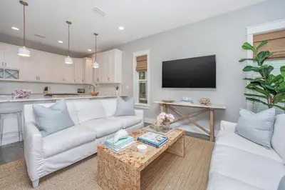a living room with a white couch and a table at 110 Surfer Lane in Inlet Beach