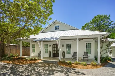 a white house with a gambrel roof at Hidden Cypress in Santa Rosa Beach