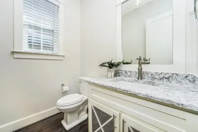 a white bathroom with a sink and a toilet at 28 Beach Bike Way in Santa Rosa Beach