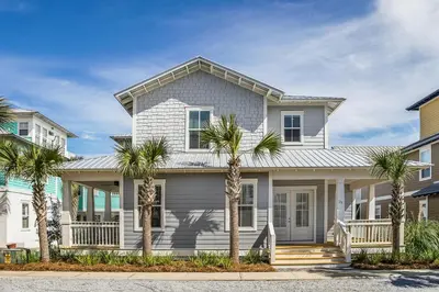 a white house with palm trees in front of it at 28 Beach Bike Way in Santa Rosa Beach