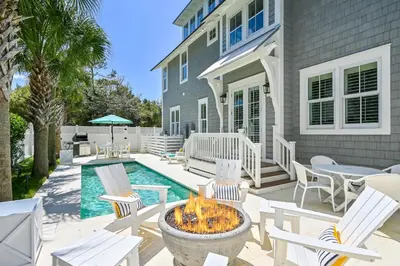 a patio with chairs and a fire pit in front of a house at 13 Madaket Way in Watersound Beach