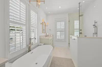 a white bathroom with a tub and a sink at 13 Madaket Way in Watersound Beach