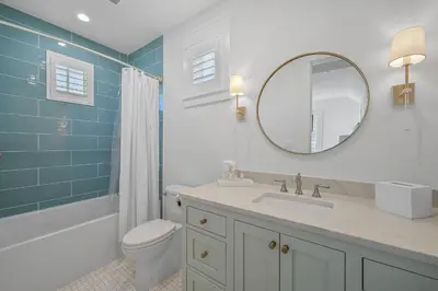 a bathroom with a sink and a toilet and a mirror at 13 Madaket Way in Watersound Beach