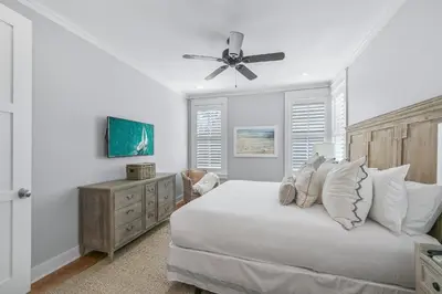 a white bedroom with a bed and a ceiling fan at 13 Madaket Way in Watersound Beach